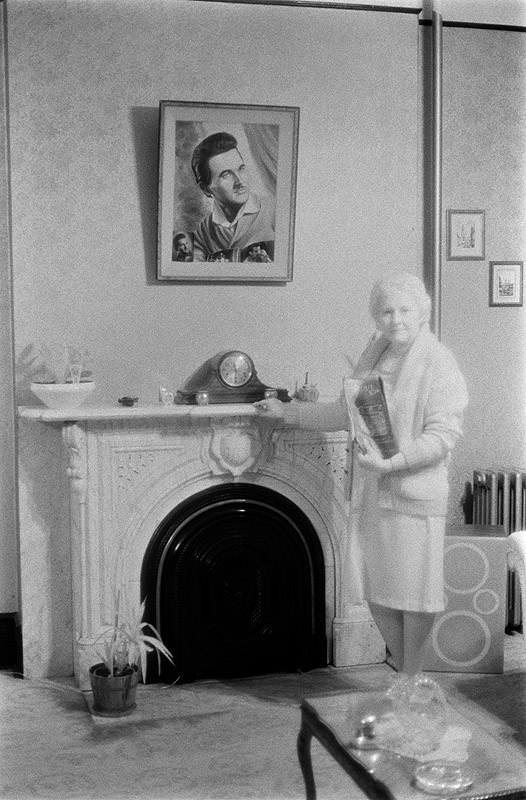 [ INFRARED PHOTO OF WOMAN STANDING BY FIREPLACE ]
