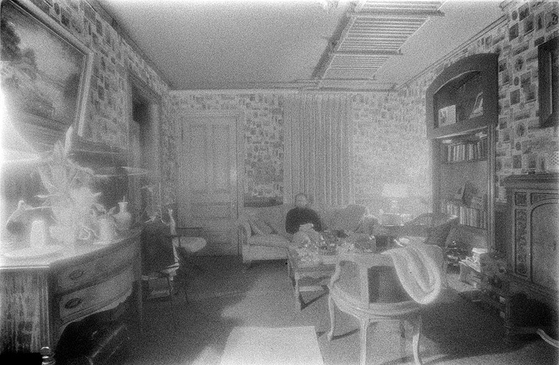 [ INFRARED PHOTO OF A ROOM WITH MAN SITTING ON SOFA ]